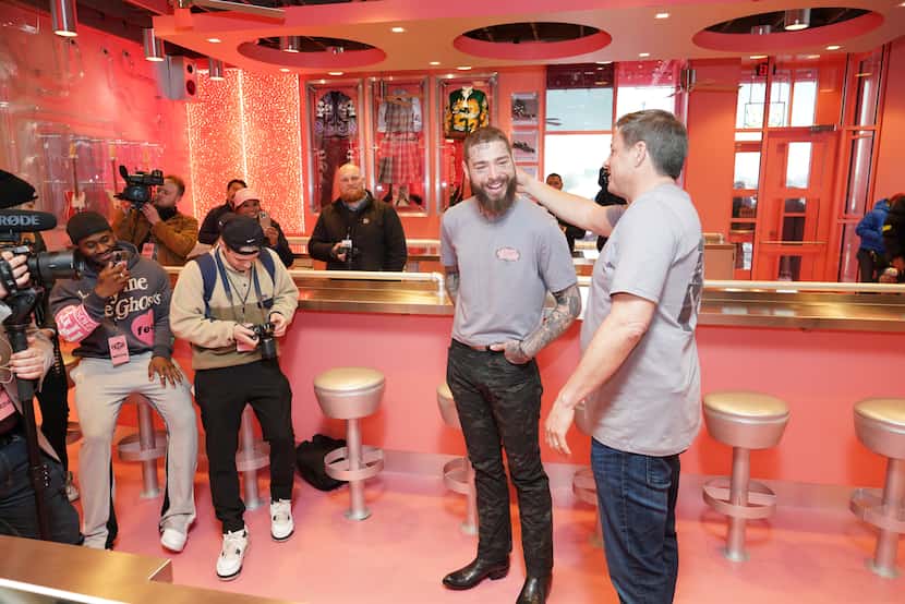 Post Malone and Raising Cane's founder Todd Graves led the grand opening on Thursday of a...
