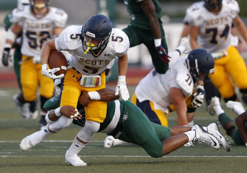 Highland Park running back Jacob Urbanczyk (5) is tackled by Waxahachie linebacker Jarvis...