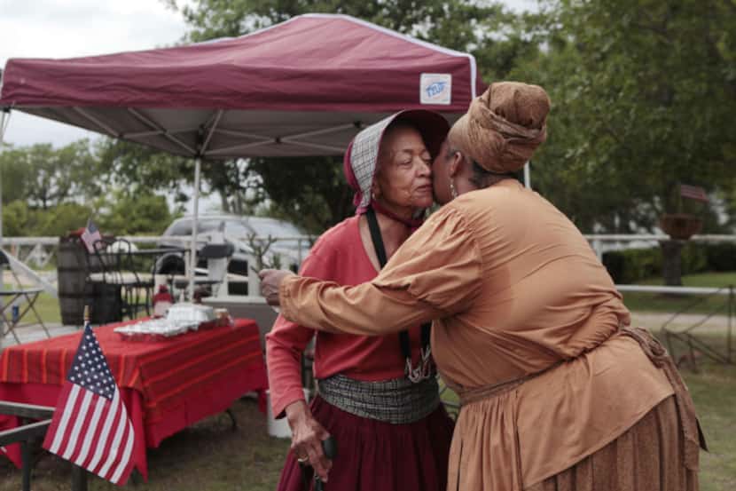 Melody Afi Bell (right) kissed Murdine Berry during the Old Town Juneteenth Celebration on...