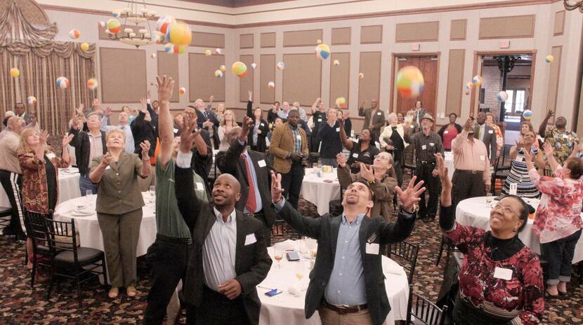 
At the closing of the first Mayor's Community Table, attendees threw small beach balls in...