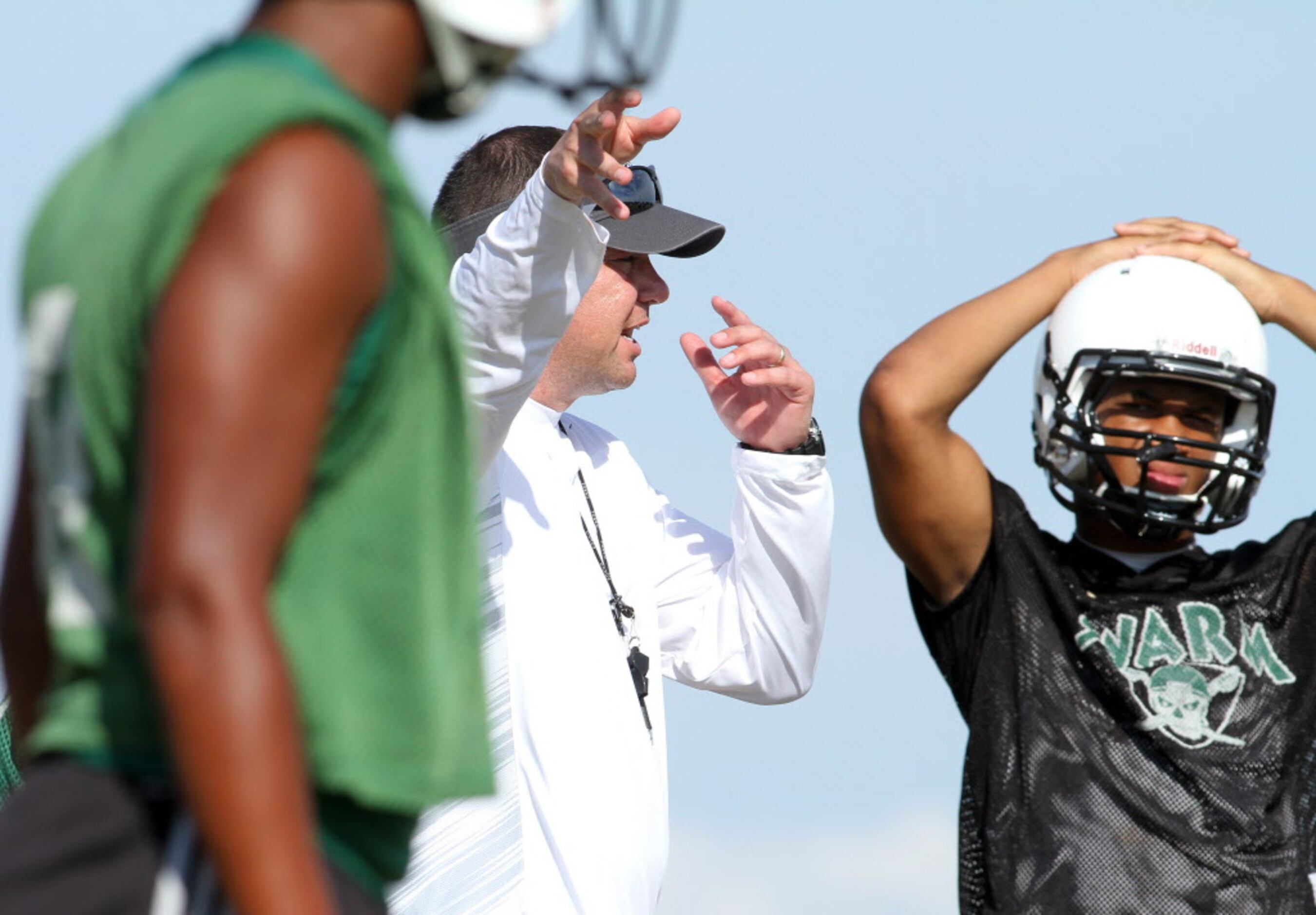 Mesquite Poteet head coach Kody Groves directs his players through opening day drills. The...