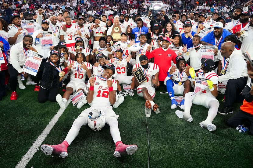 Duncanville players pose for a team photo with the championship trophy after a victory over...