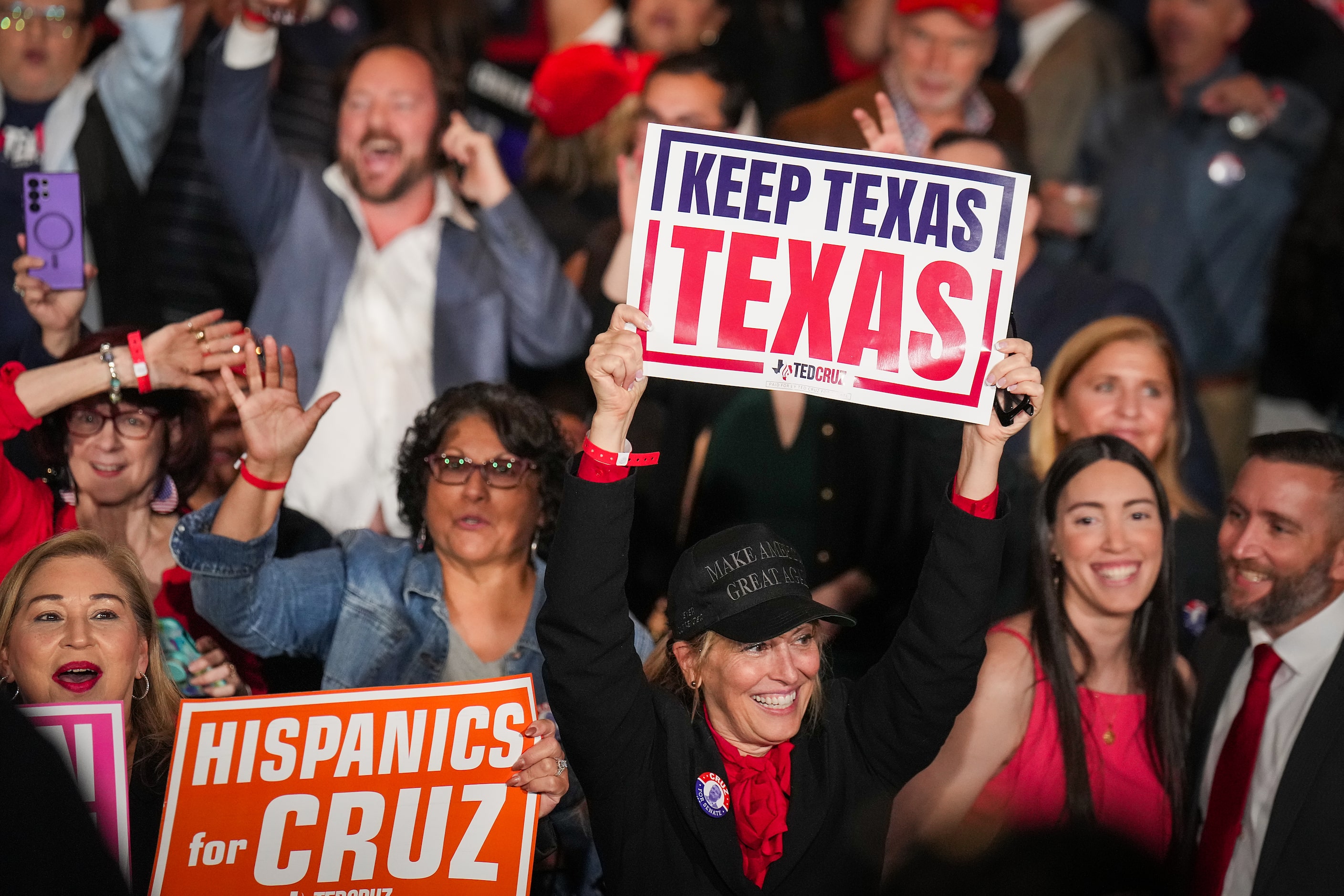 Supporters celebrate as Fox News calls the election for their candidate during an election...