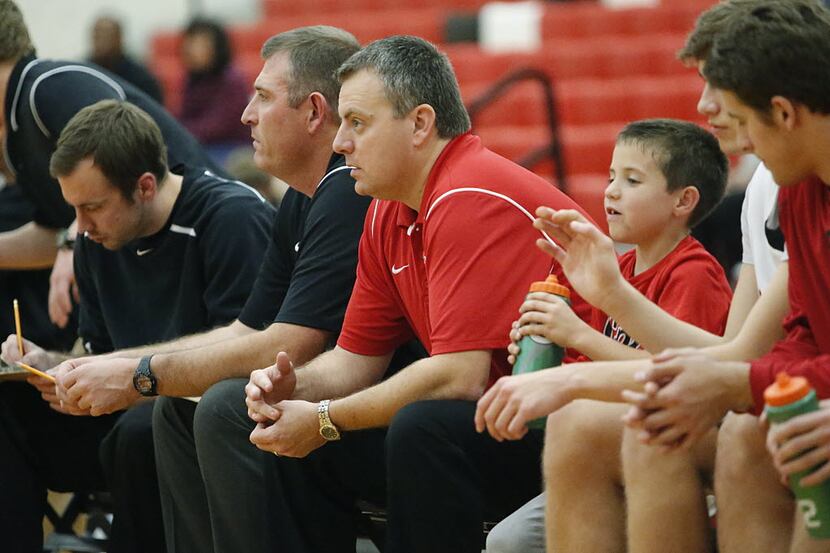 FILE - Coppell High School Head Coach Kit Pehl (center) looks on from the bench just after...