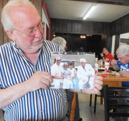 Sanders' nephew, sharing scrapbook memories with Tribune writer Jay Jones.