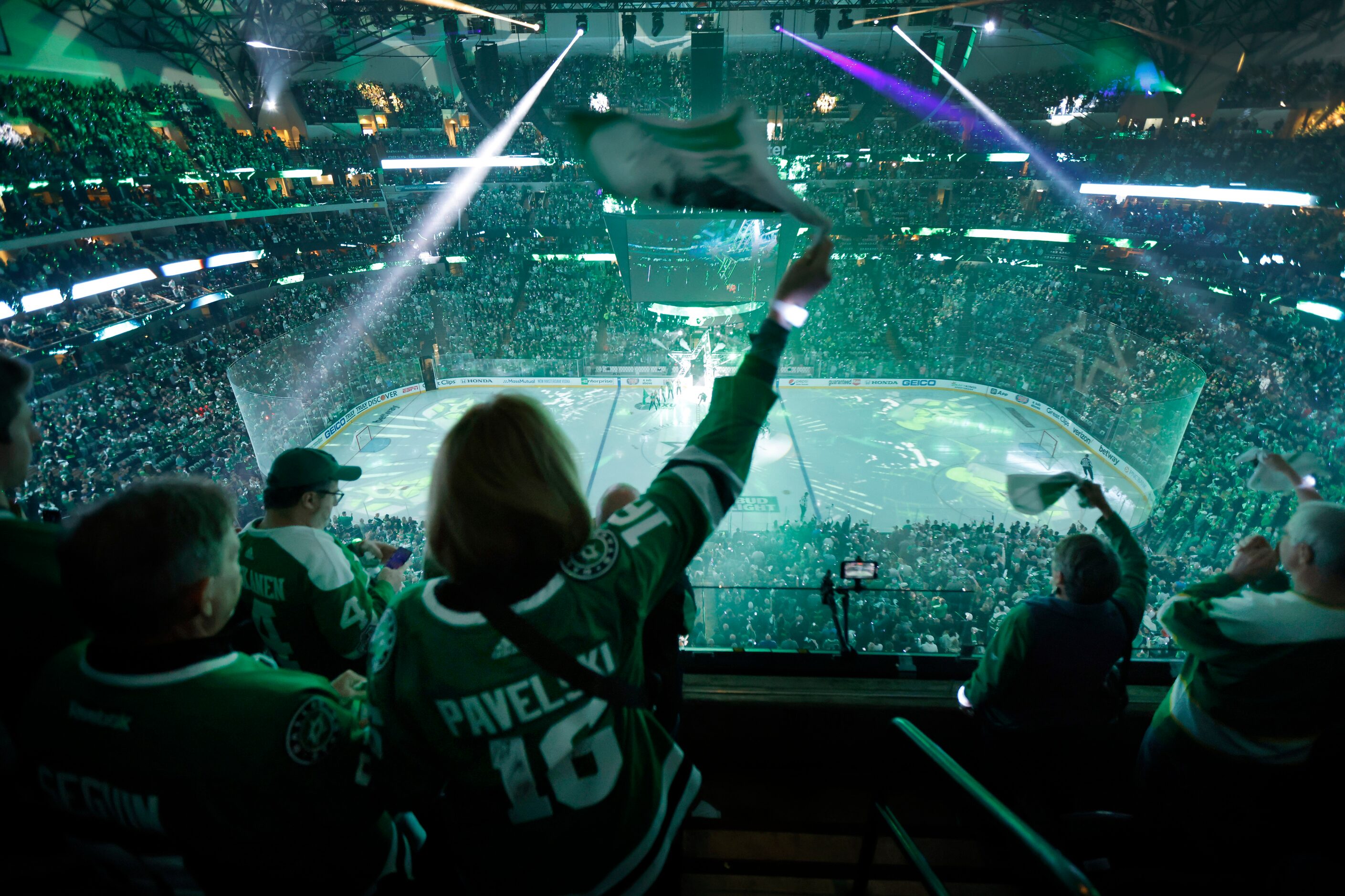 Dallas Stars fan Frances Hafer of Dallas waves her towel during a laser and pregame video...