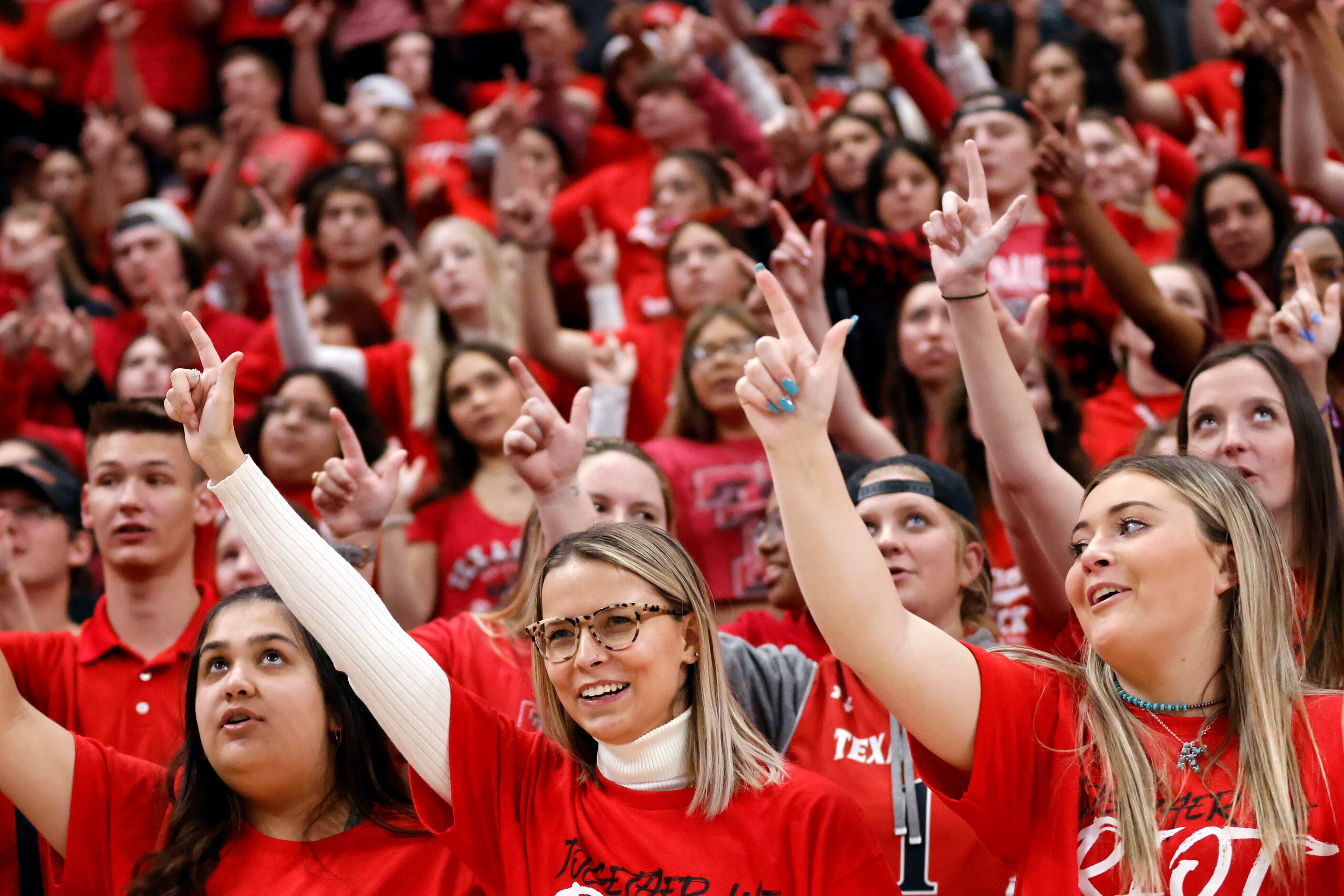 The Texas Tech Red Raiders student body get their ‘guns up’ hand sign before their team...