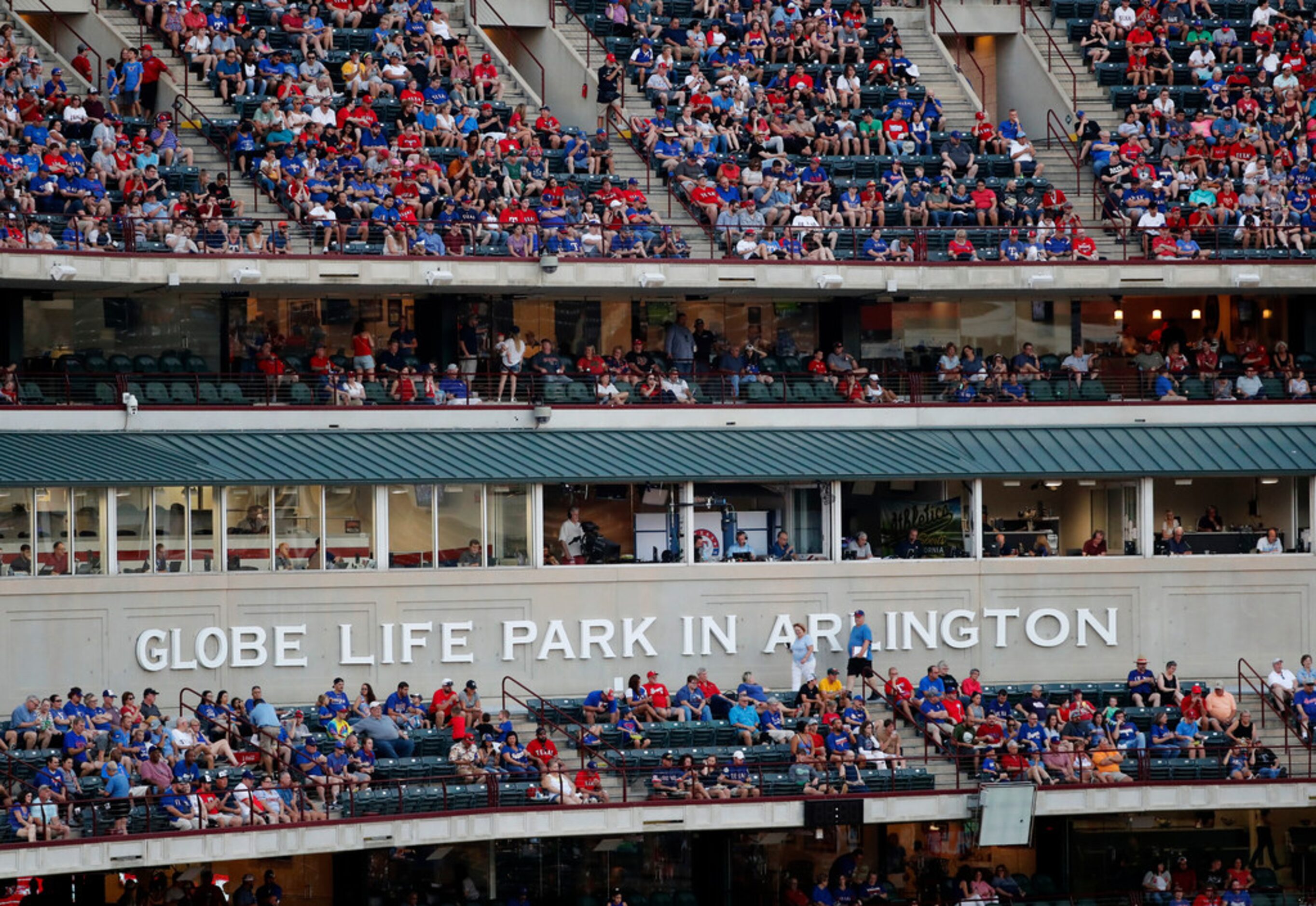 Fans watch play between the Oakland Athletics and the Texas Rangers a Globe Life Park in...