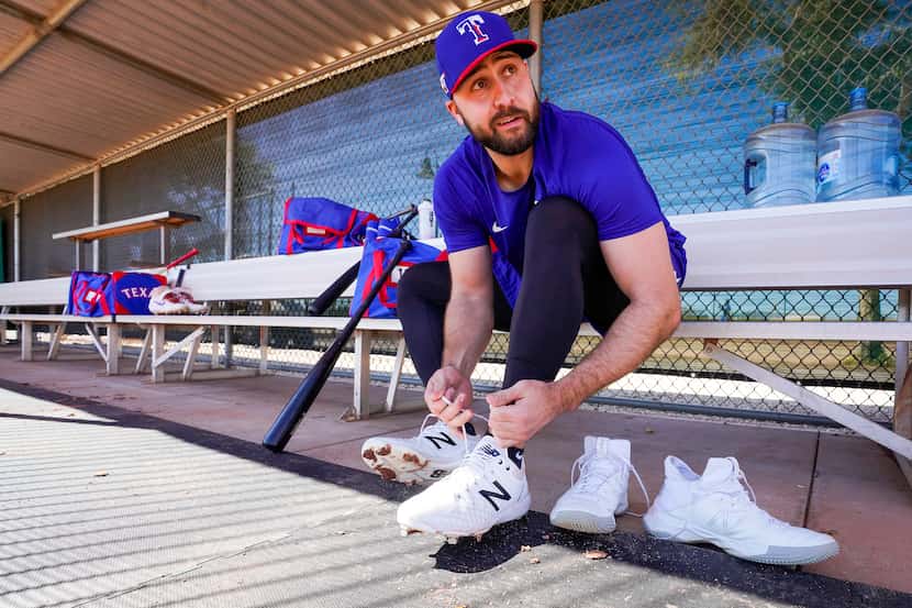 Texas Rangers outfielder Joey Gallo laces up his cleats before taking batting practice...
