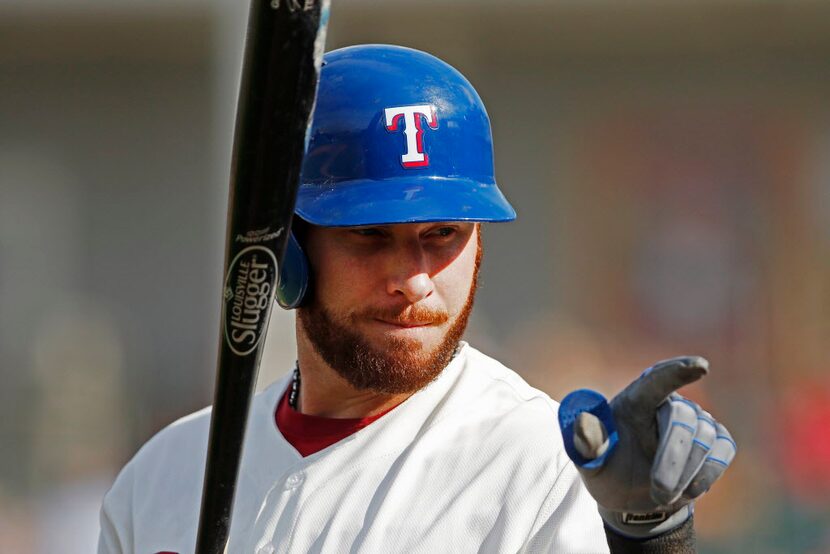 Frisco RoughRiders Josh Hamilton points at a young fan while he waits to bat during the game...