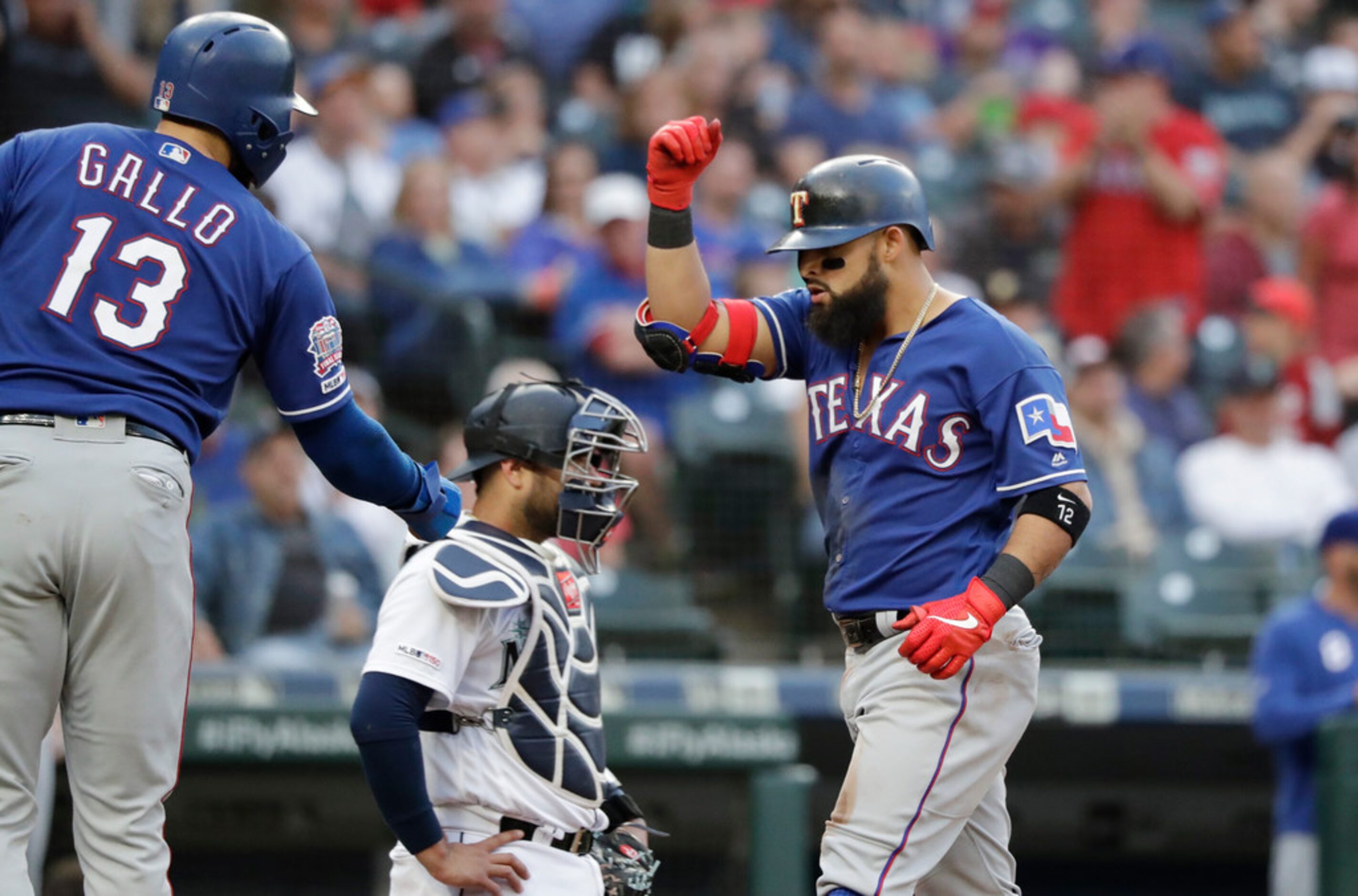 Texas Rangers' Rougned Odor, right, shares congratulations on his two-run home run with Joey...