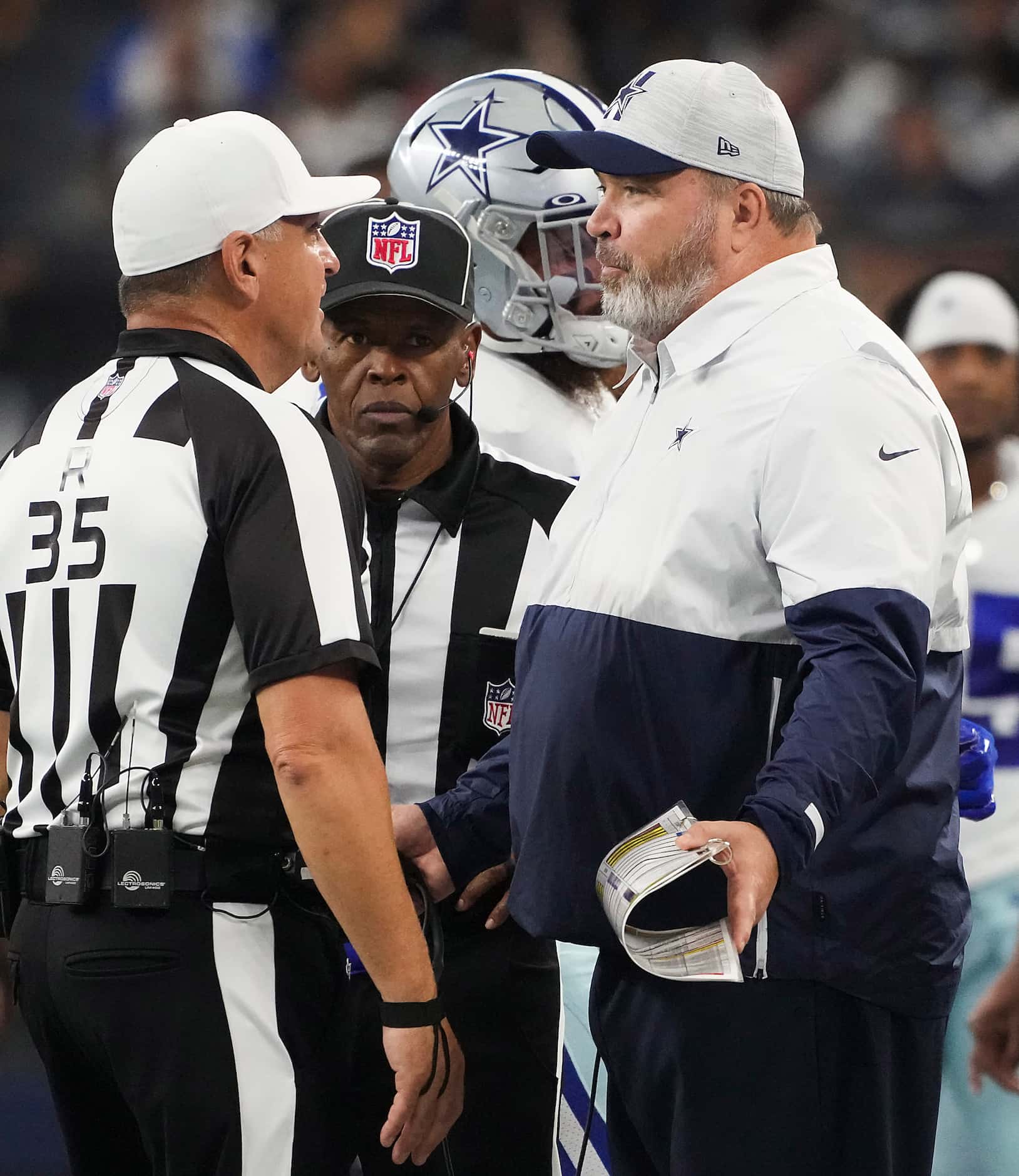 Dallas Cowboys head coach Mike McCarthy talks to referee John Hussey during the first half...