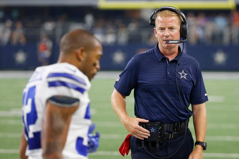 Dallas Cowboys head coach Jason Garrett looks at Dallas Cowboys cornerback Orlando Scandrick...