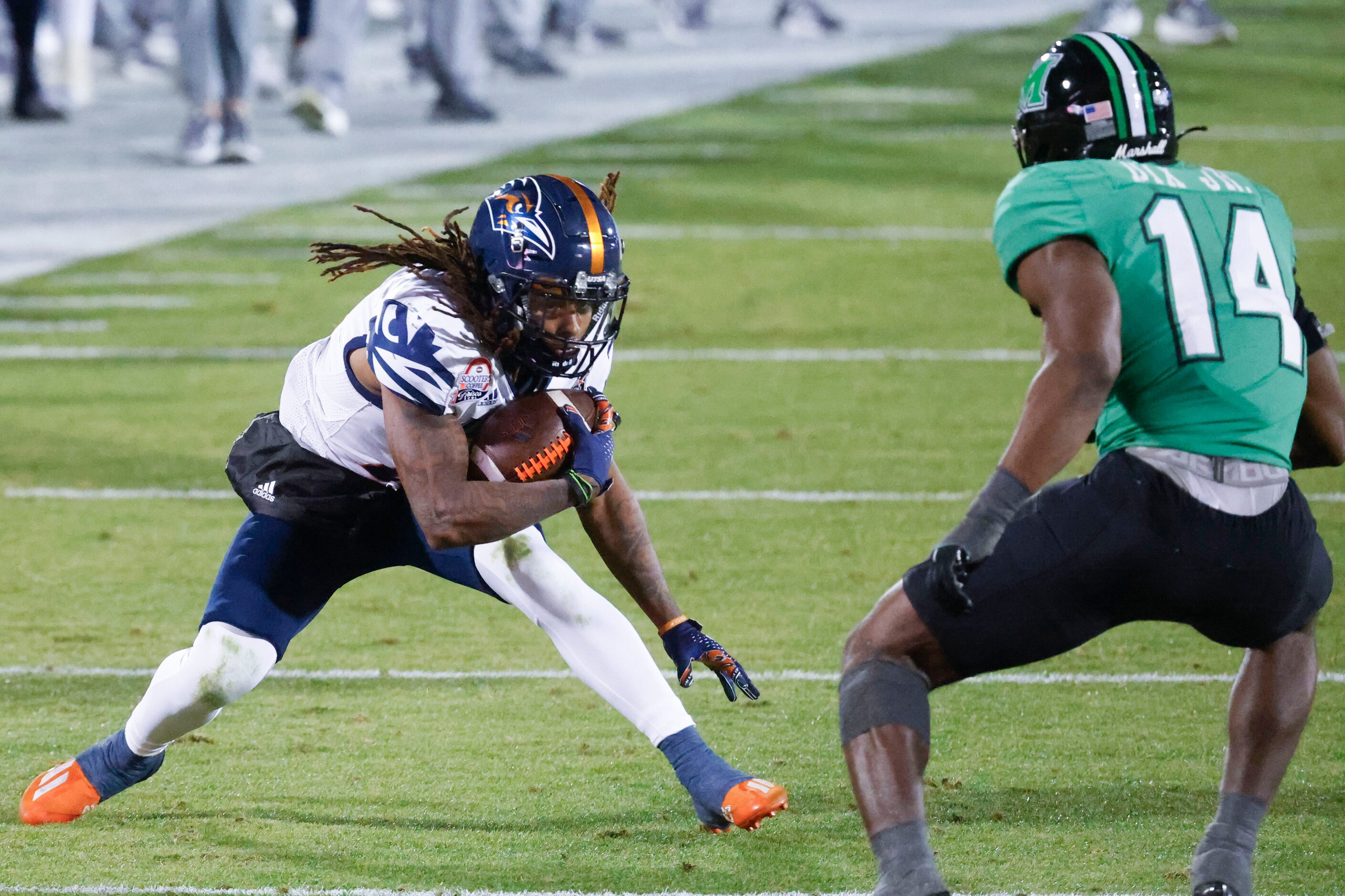 UTSA running back Robert Henry (left) looks to runs past Marshall linebacker Stephen Dix Jr....