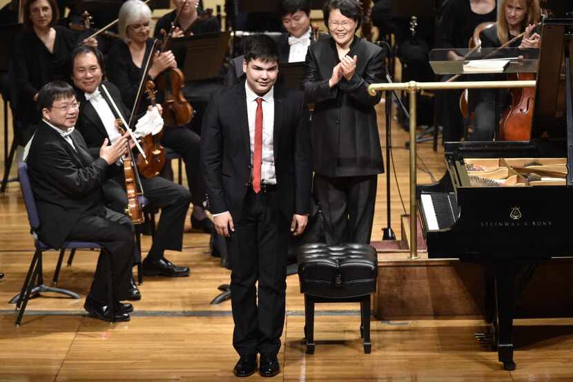 Alim Beisembayev, of Kazakhstan, bows to the crowd after playing Tchaikovsky's Piano...