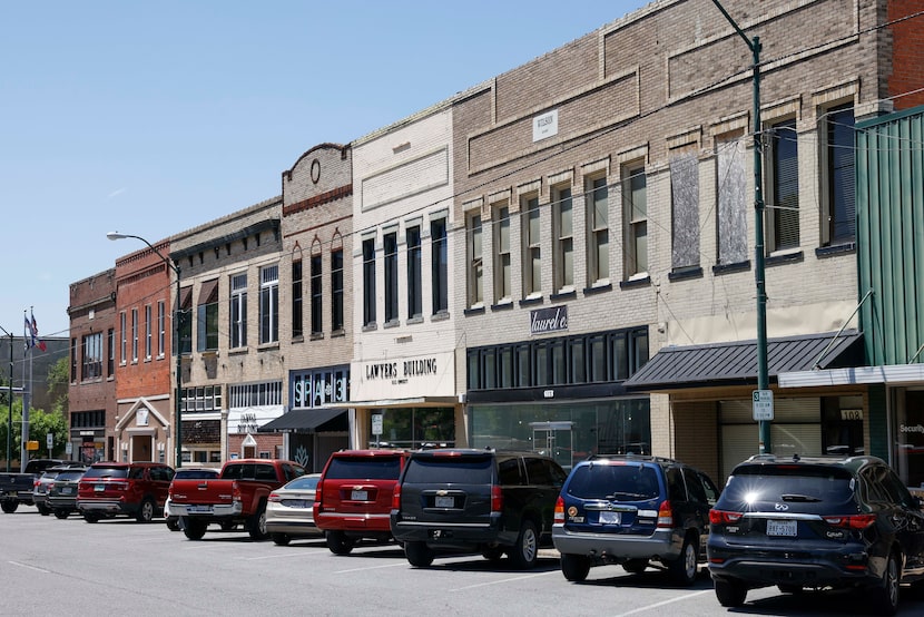 Shops and various businesses line the street in the old town square in Sherman, giving the...