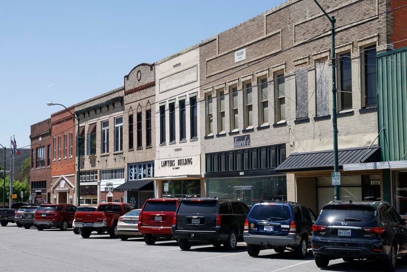 Shops and various businesses line the street in the old town square in Sherman, giving the...