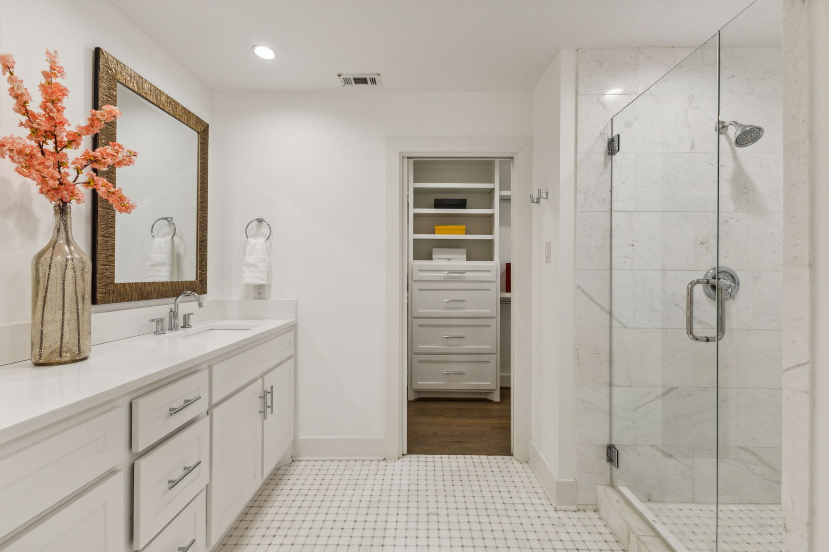 The primary bathroom has two sinks, a walk-in shower and a walk-in closet.