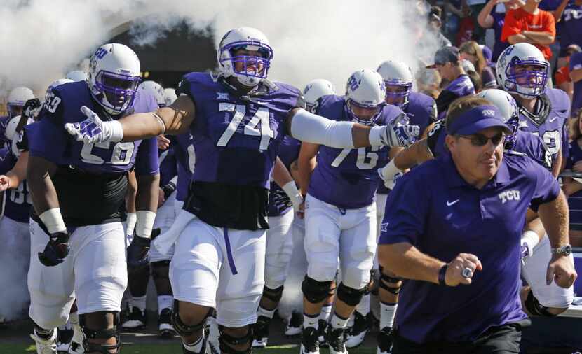 TCU offensive lineman Halapoulivaati Vaitai (74) gets pumped up as he takes the field with...