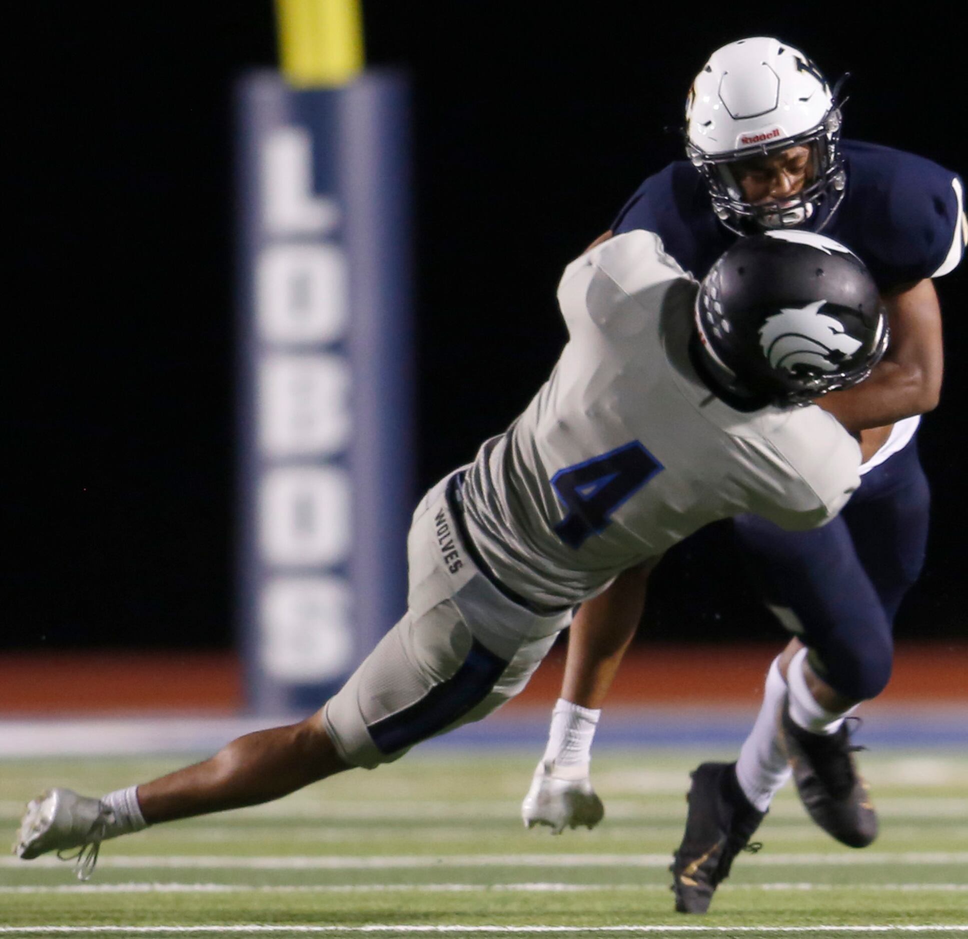 Little Elm running back Jason Jackson (5) is stopped short of a first down by a flying...