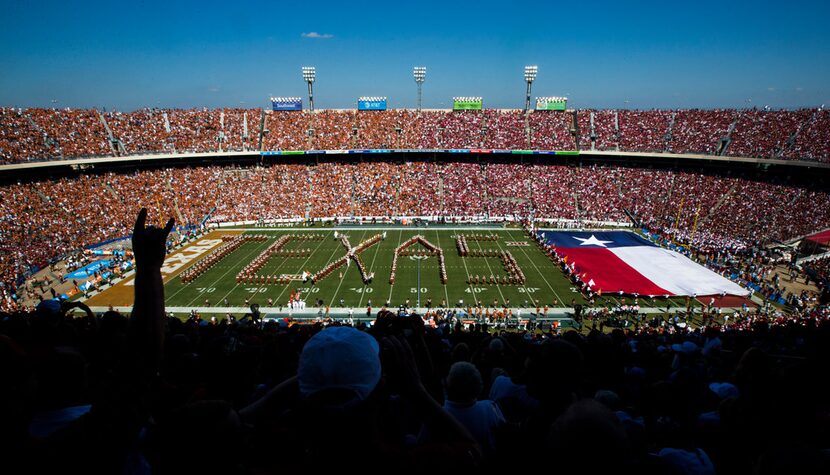 Texas Longhorns fans cheer as the band performs before the AT&T Red River Showdown college...