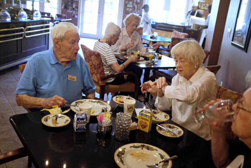 (From left) Paul Davis talks with his wife, Betty Davis, as the wrap up breakfast with Marie...