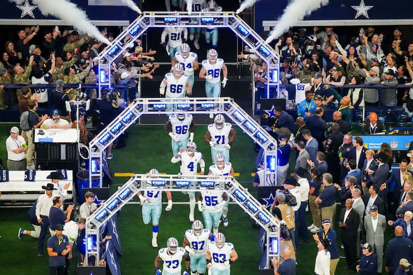 Dallas Cowboys quarterback Dak Prescott (4) points skyward as the team takes the field...