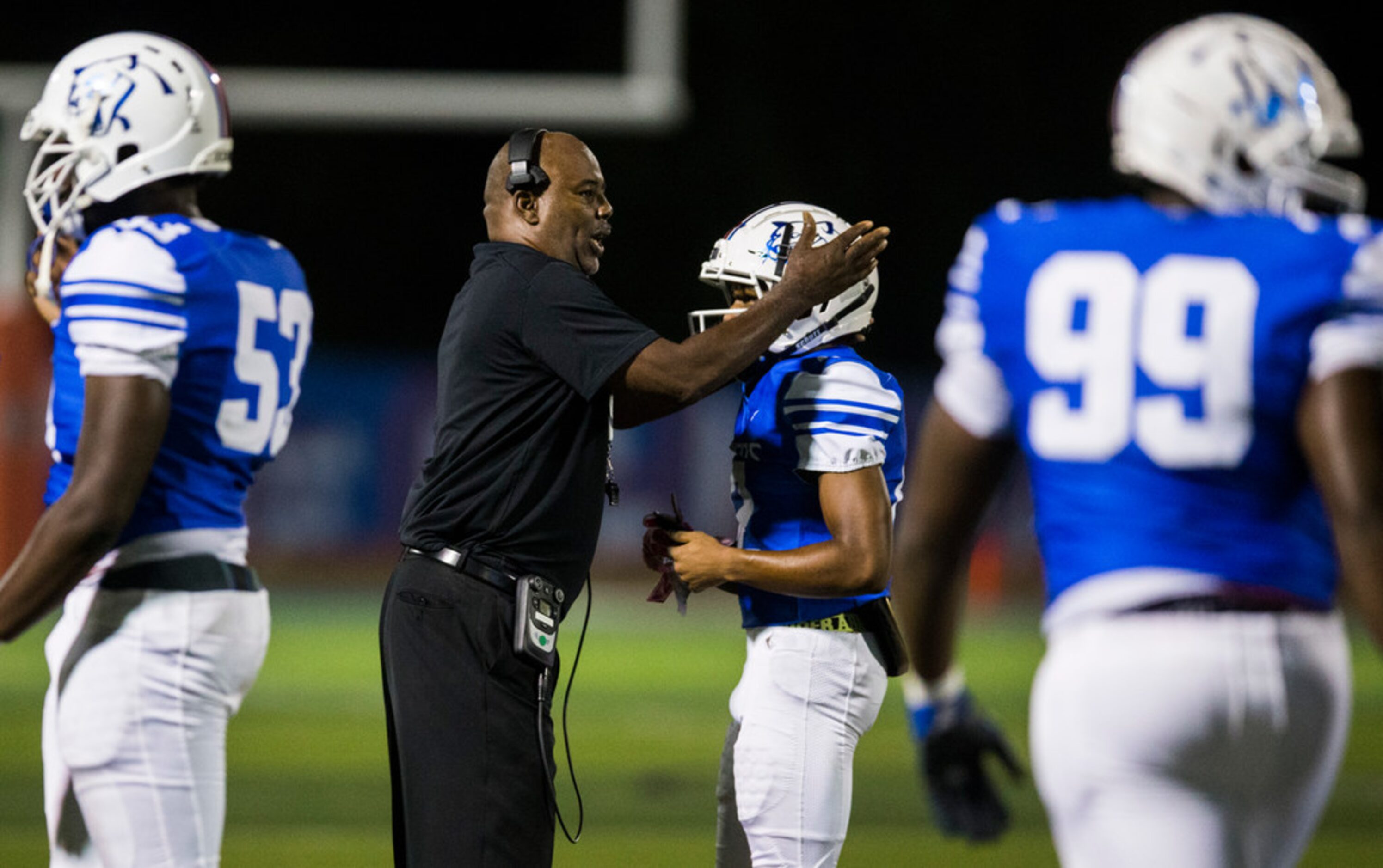 Duncanville head coach Reginald Samples congratulates players after a touchdown during the...