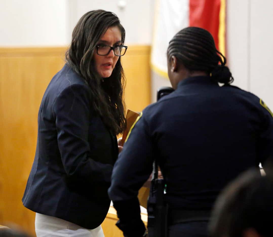 Defendant Brenda Delgado (left) asks a question of the bailiff following the first day of...