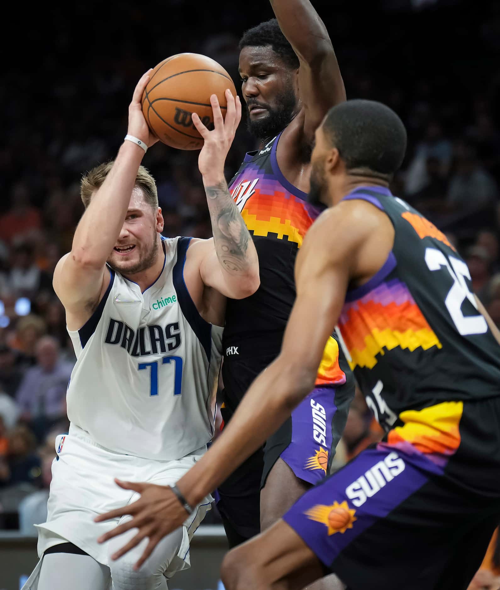 Dallas Mavericks guard Luka Doncic (77) tries to drive to the basket as Phoenix Suns center...