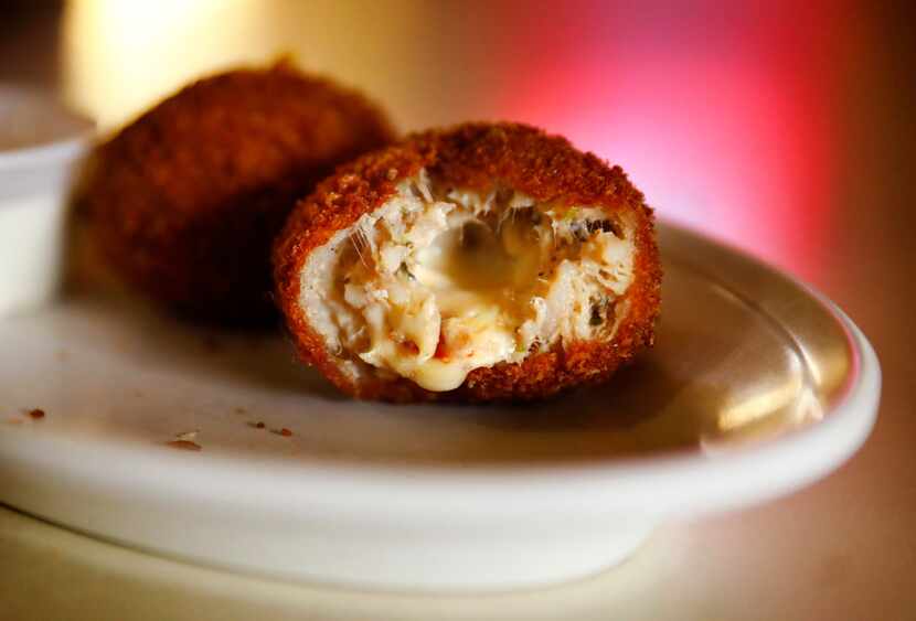 Deep-fried boudin balls made with pork meat, rice and pepper jack cheese are served in the...