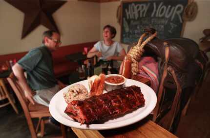 In this DMN file photo, customers enjoy a plate of meat and sides Peggy Sue BBQ in Snider...