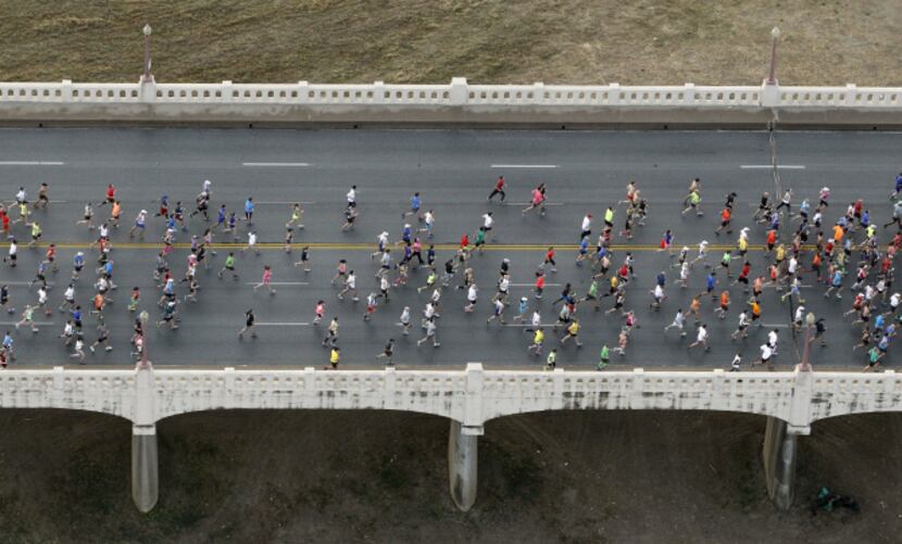 Runners make their way across the Commerce Street bridge during the MetroPCS Dallas Marathon...