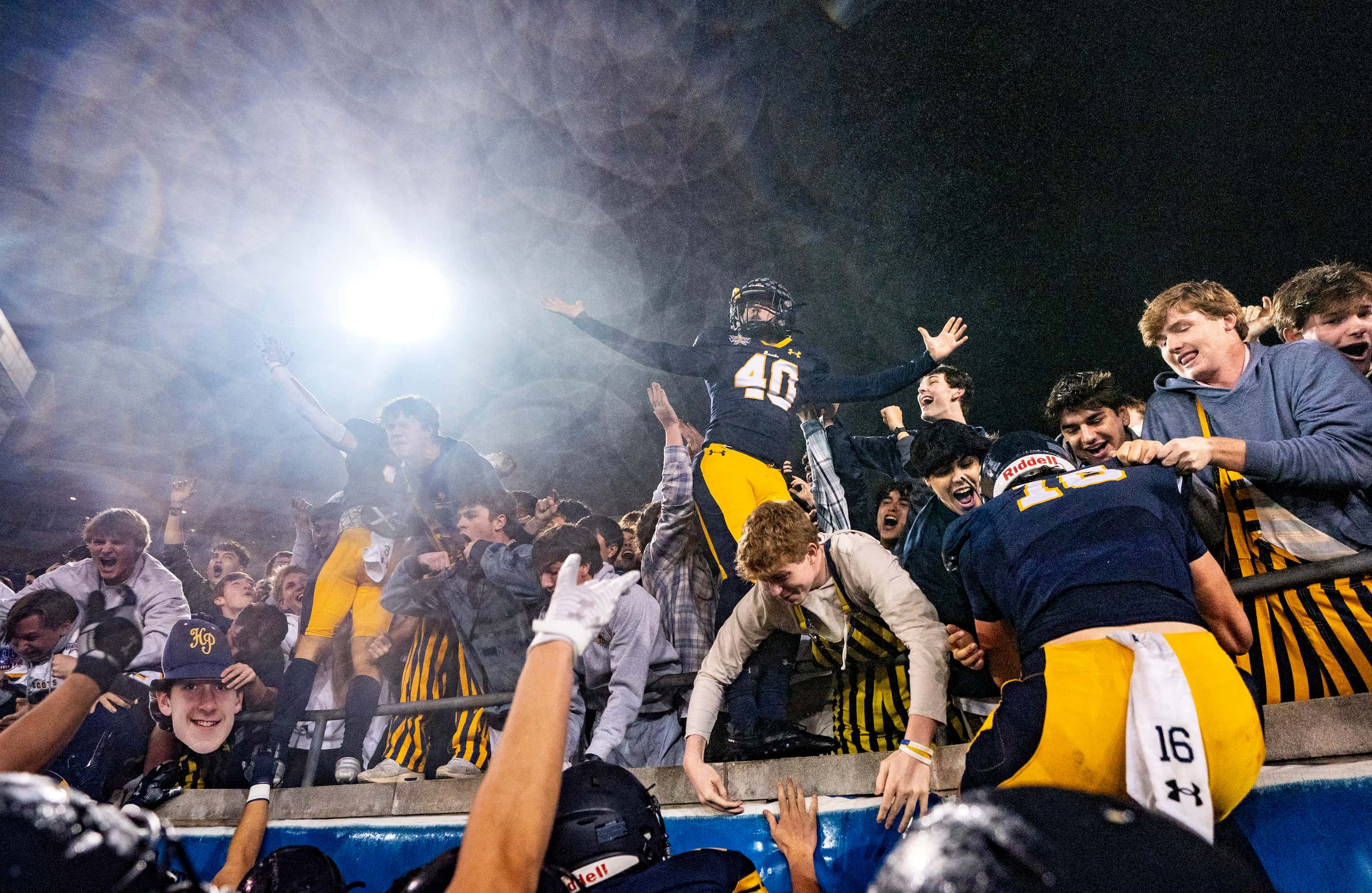 Highland Park senior kicker Nicholas Rigas (4) celebrates in the student section after...
