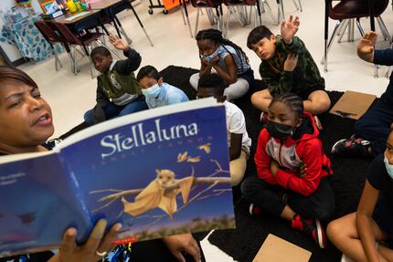 Teacher Phyllis Pleasant reads the book “Stellaluna” to students during summer school at...