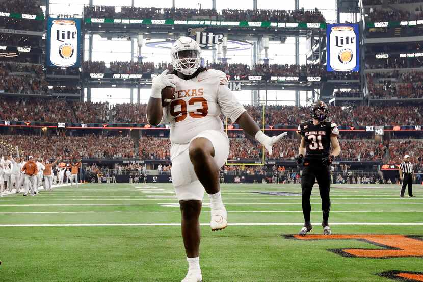 FILE - Texas defensive lineman T'Vondre Sweat (93) strikes a pose in the end zone after...