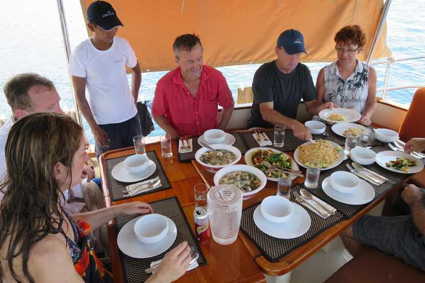 Guests enjoy one of the many delicious Thai meals on Burma Boating's cruise.