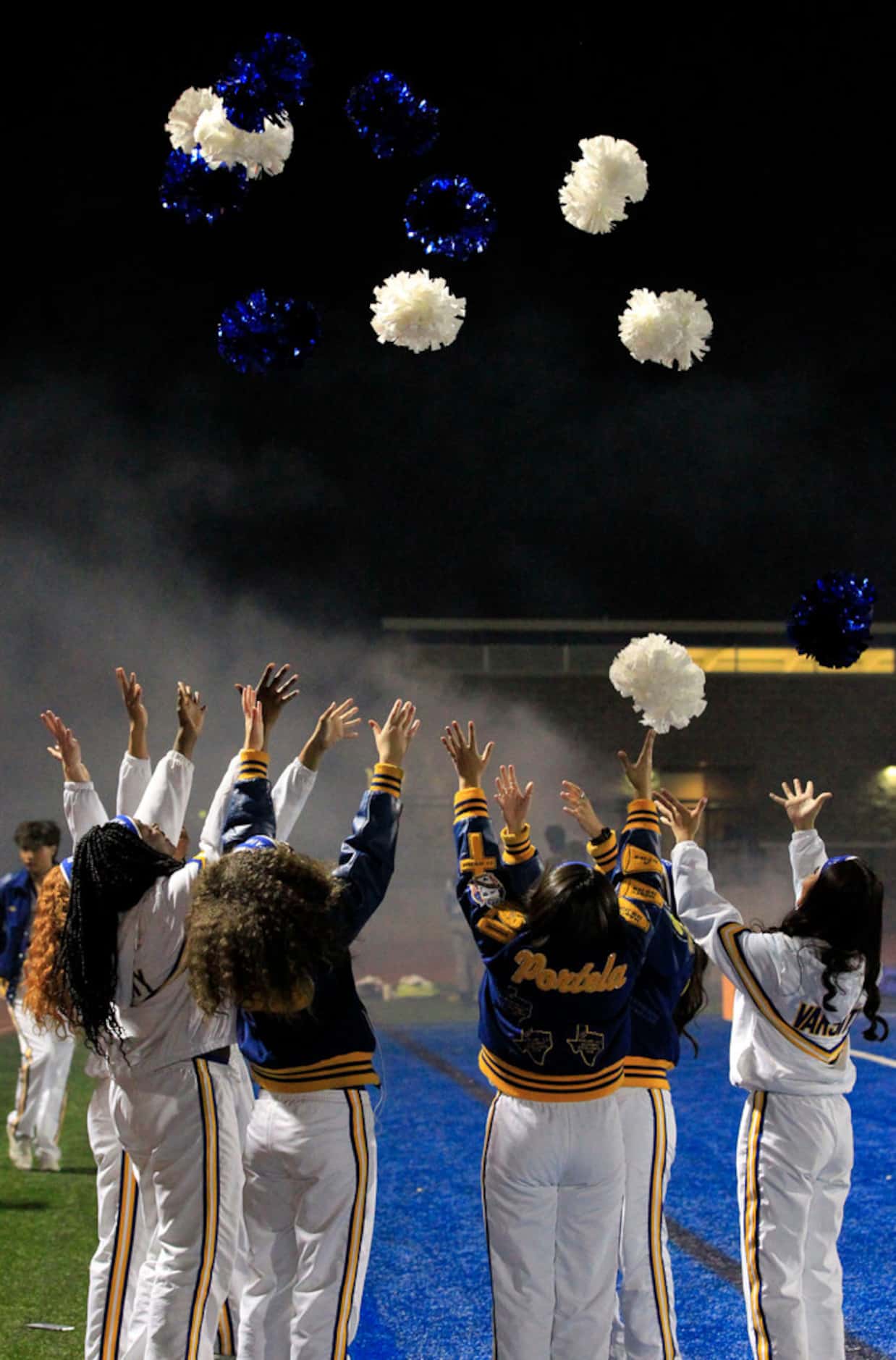 Lakeview cheerleaders throw up poms before the first half of the Lakeview Centennial Vs....