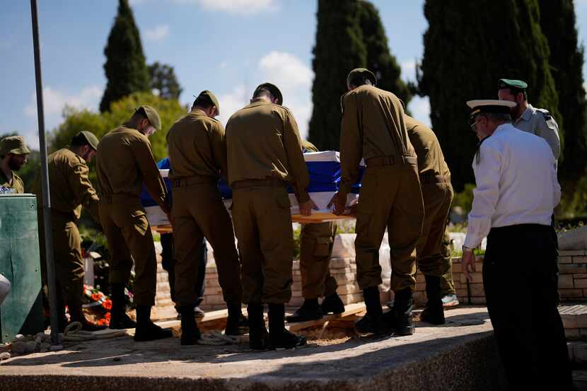Israeli soldiers carry the flag-covered coffin of Maya Villalobo during her funeral at the...