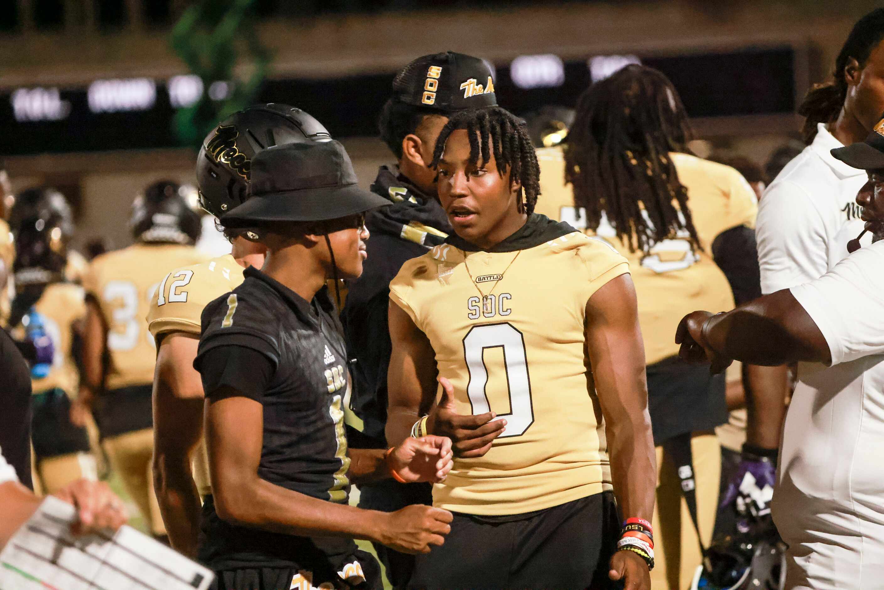 South Oak Cliff High School Jayvon Thomas (0) talks with teammates on the sidelines during...