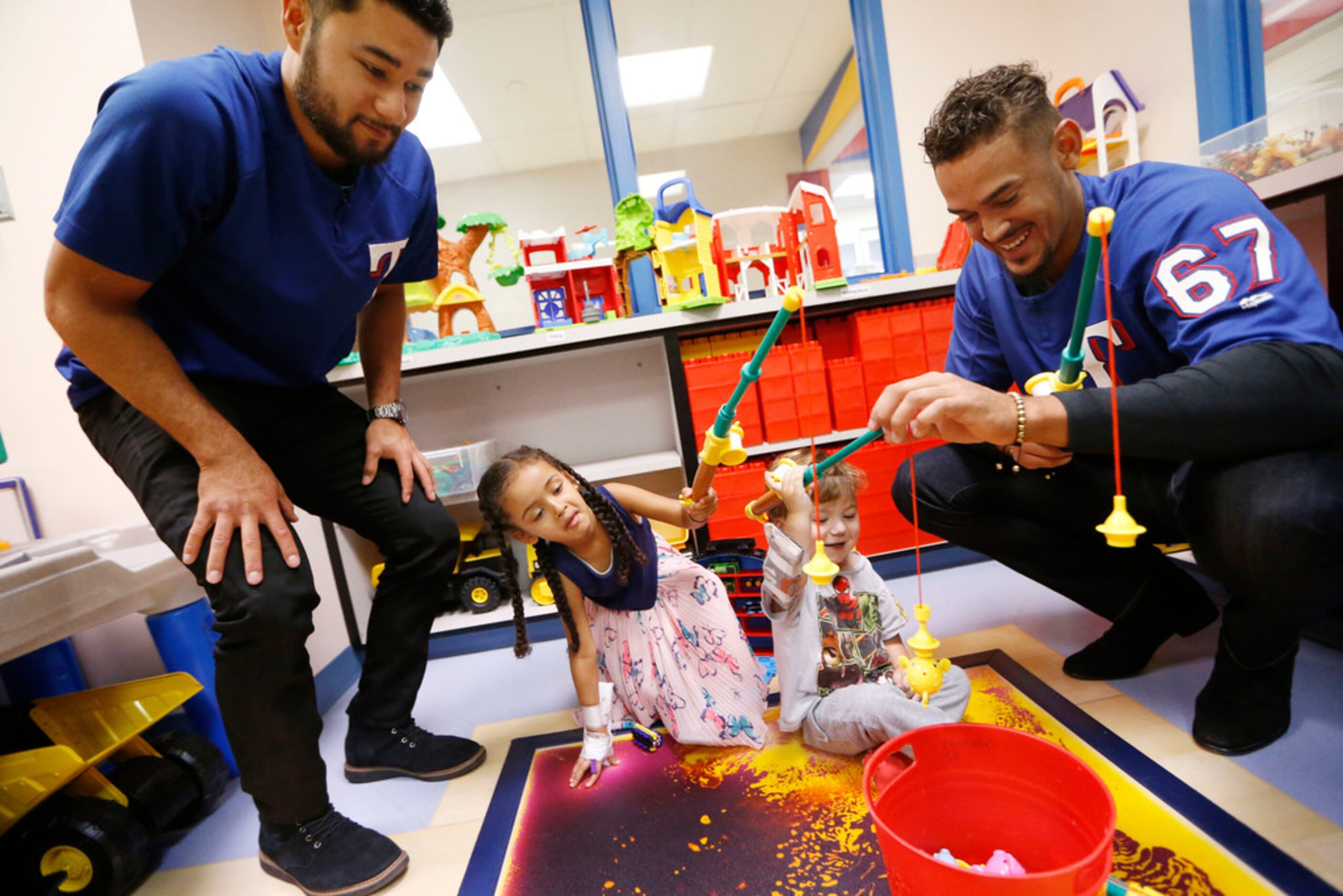 Texas Rangers'  Isiah Kiner-Falefa (left)  and Ronald Guzman (right) play a fishing game...