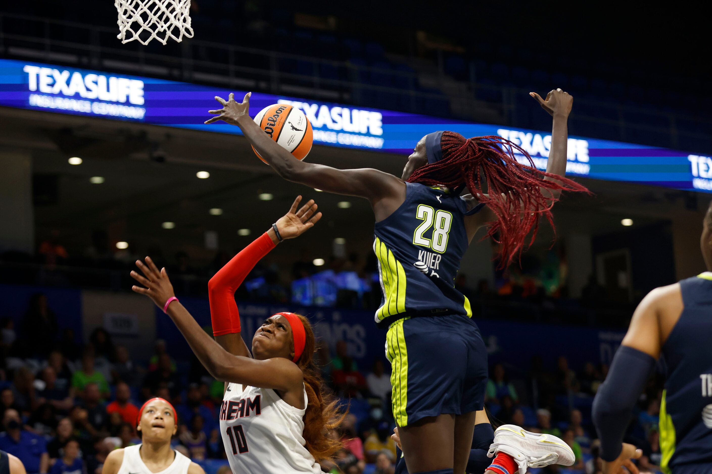 Atlanta Dream guard Courtney Williams (10) tries to make a shot as she is defended by Dallas...