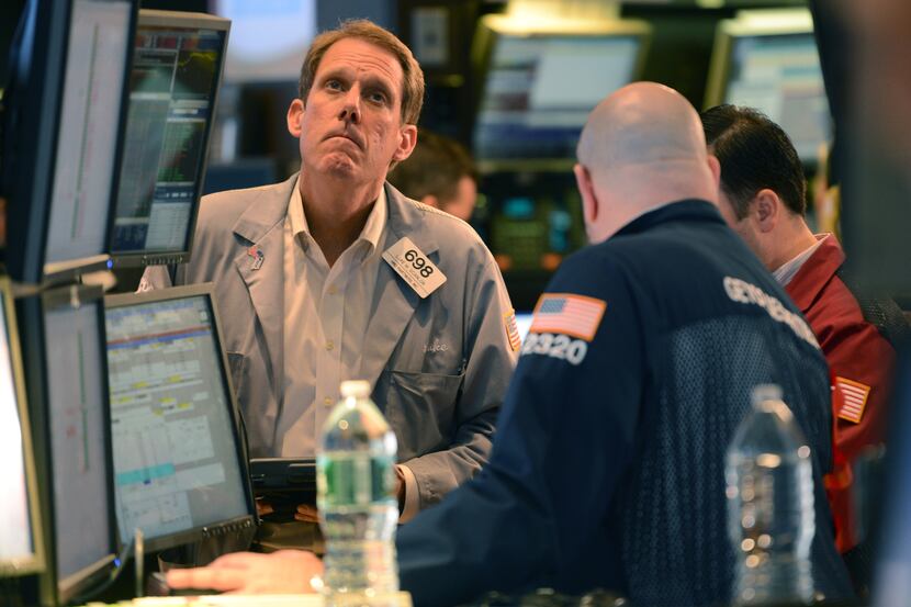 Luke Scanlon, left, of MND Partners Inc. works on the floor of the New York Stock Exchange...