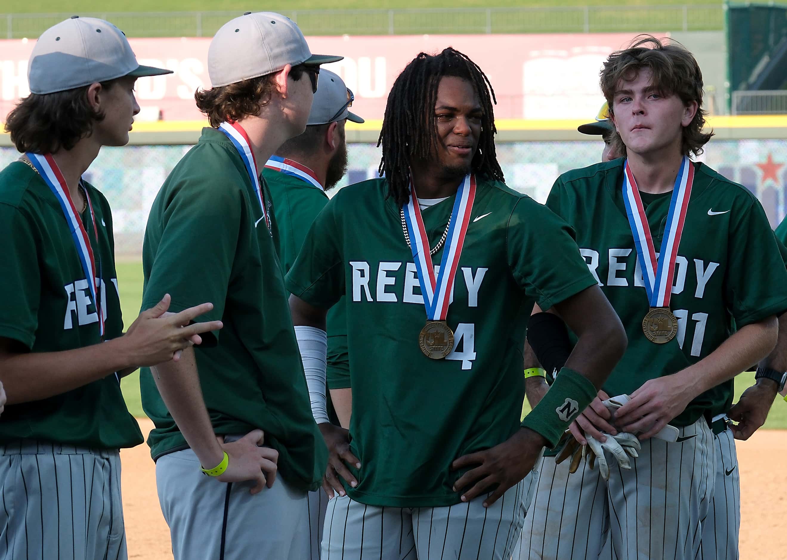 Frisco Reedy Ryan Alexander, (4), center, and teammates try to hold back tears after...