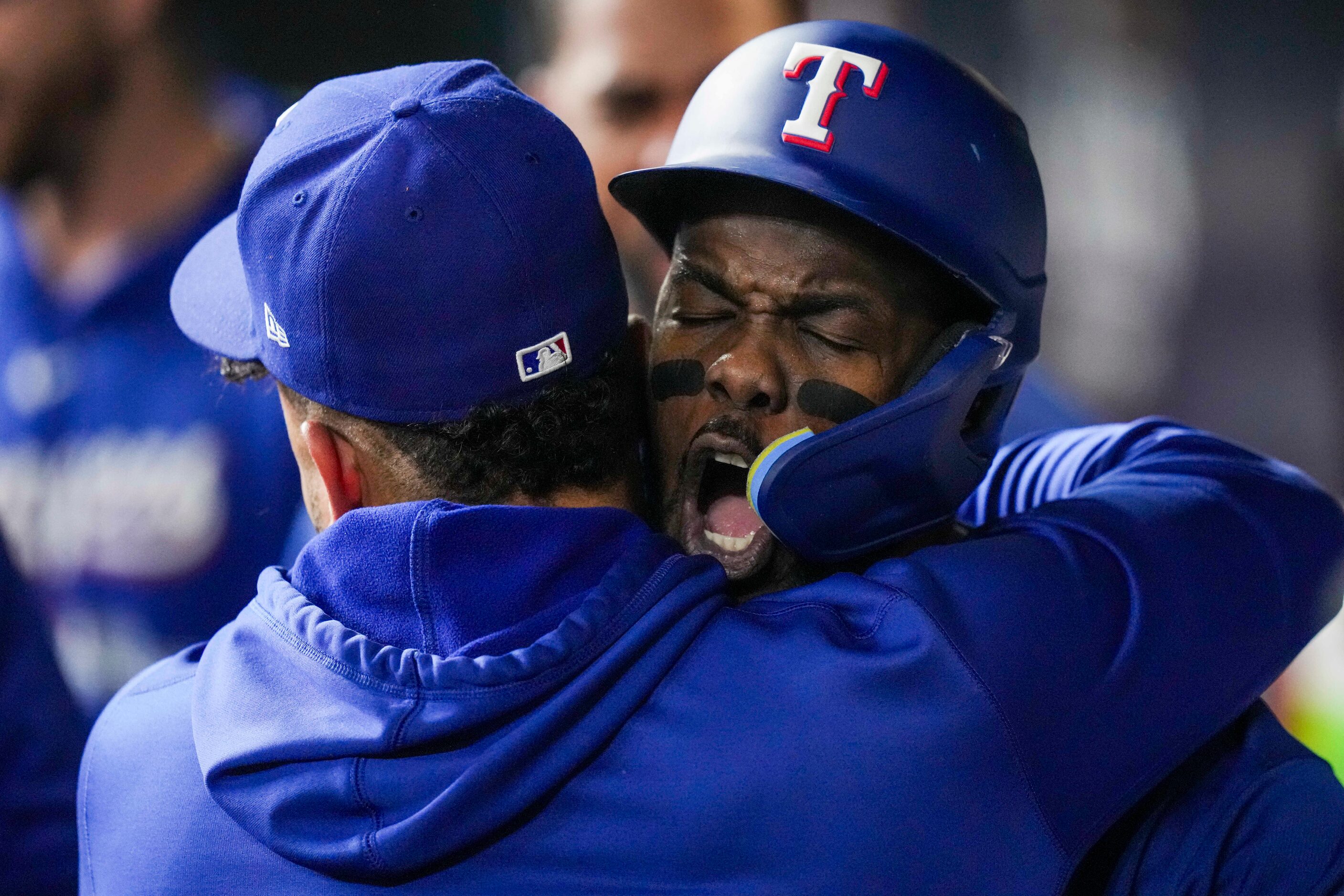 Texas Rangers right fielder Adolis Garcia celebrates with teammates after hitting a home run...