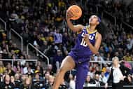 LSU forward Angel Reese (10) puts up a shot against Iowa during the first quarter of an...