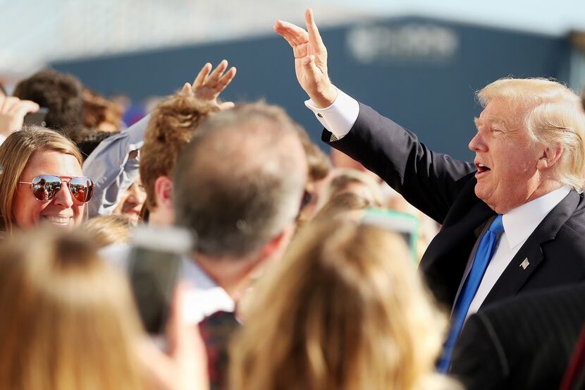 President Donald Trump greets supporters after arriving at Love Field in Dallas Wednesday...