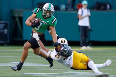 Southlake Carroll running back Riley Wormley (9) shakes Highland Park’s Jack Morse (49) in...