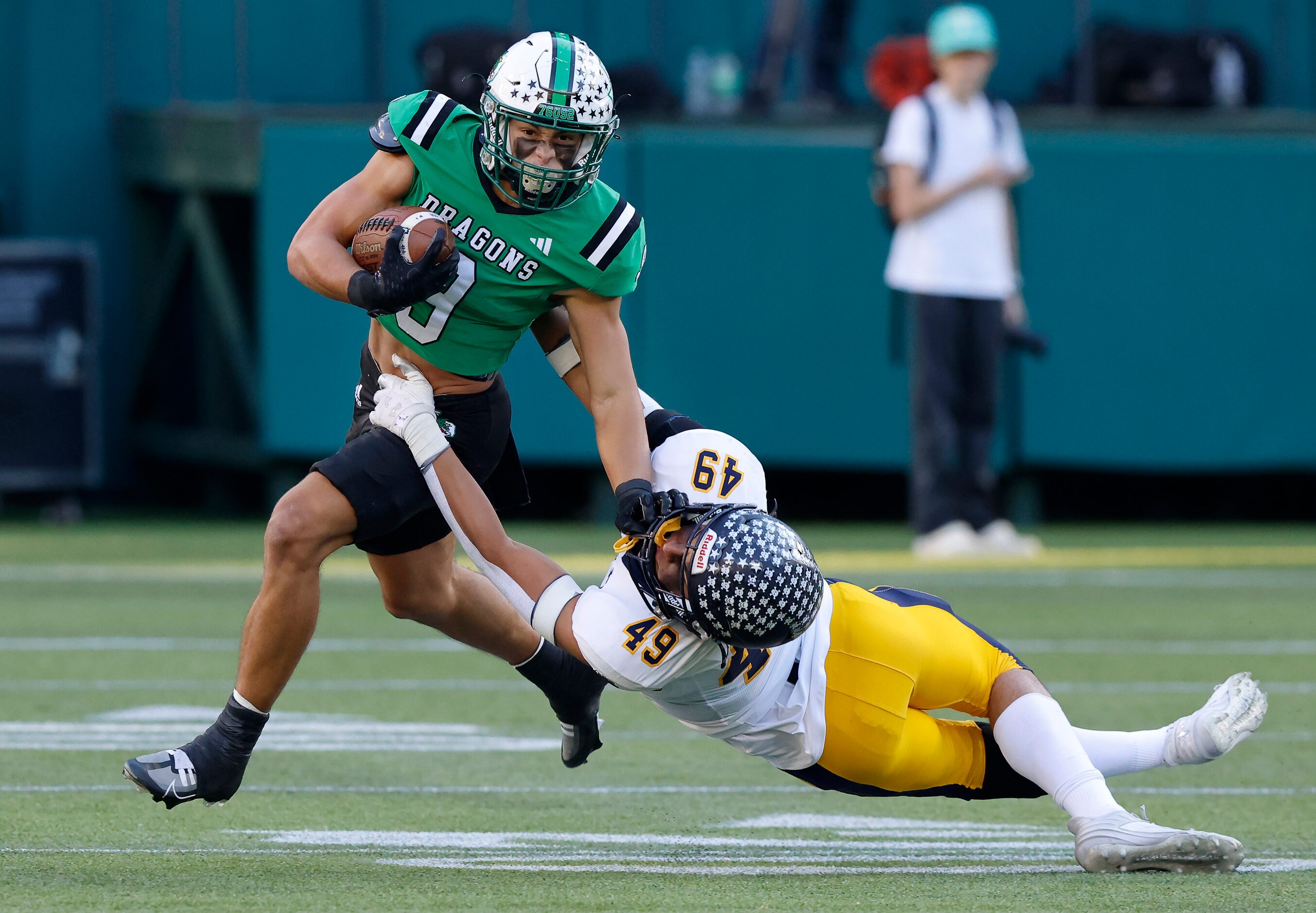 Southlake Carroll running back Riley Wormley (9) shakes Highland Park’s Jack Morse (49) in...