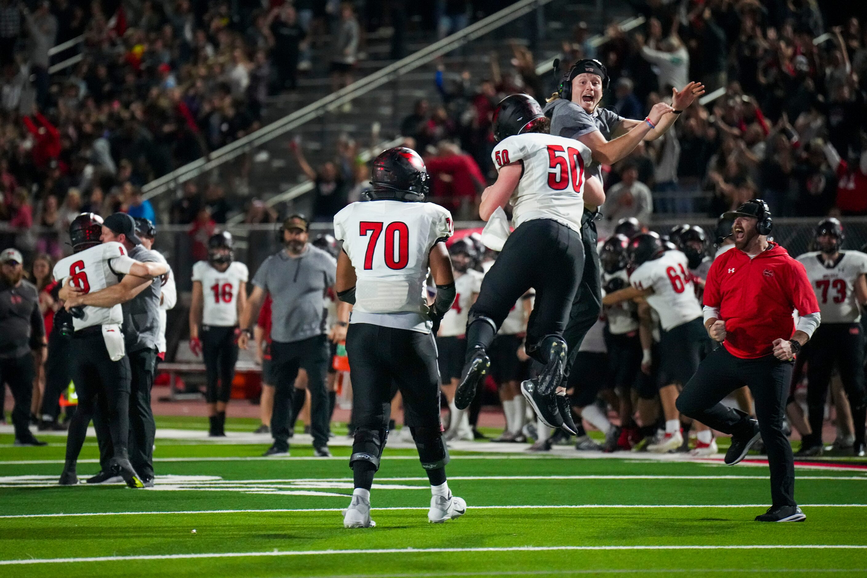 Melissa lineman Luke Demel (50) and lineman Trevor Goosby (70) celebrate with coaches after...